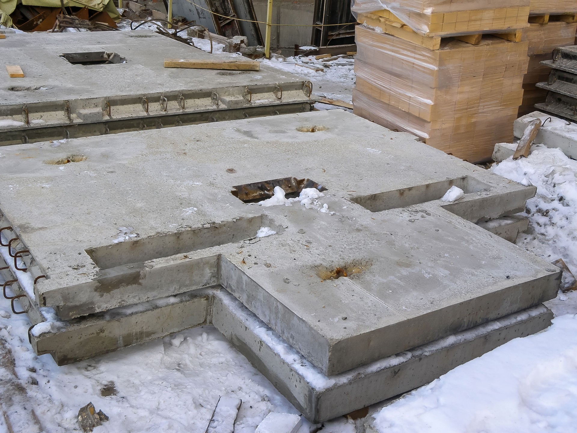 Concrete slabs stacked on a construction site, showcasing industrial and architectural materials.
